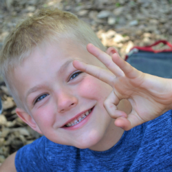 Smiling kid giving the OK sign