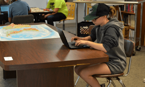 Student working on a computer at a table